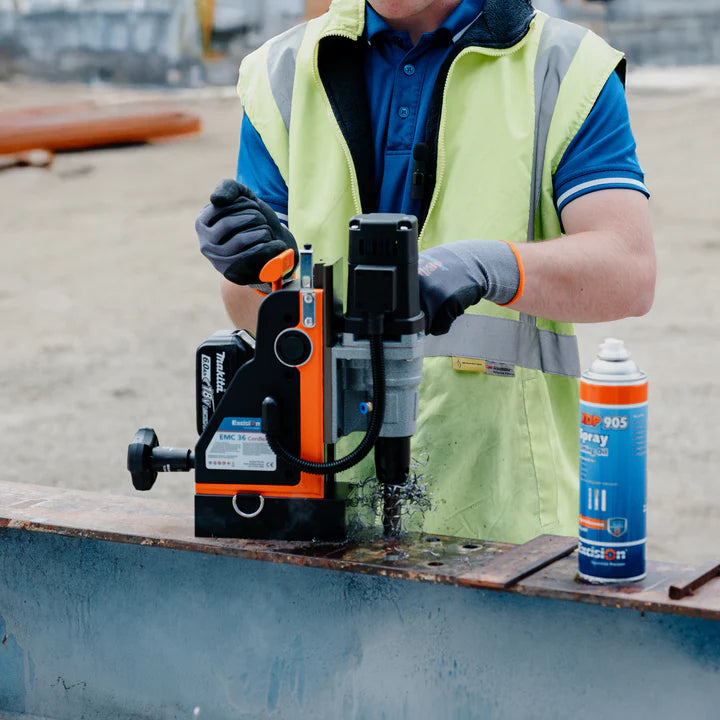 Man standing and using the EMC36 Cordless Magnetic Drill on a work site