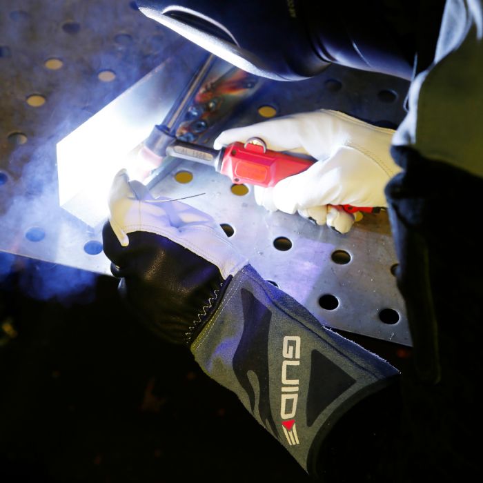 Person wearing guide 1230 gloves tig welding