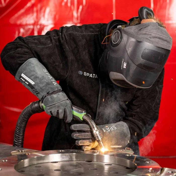 Person welding metal with protective gear and wearing Spata Pro HD welding gloves