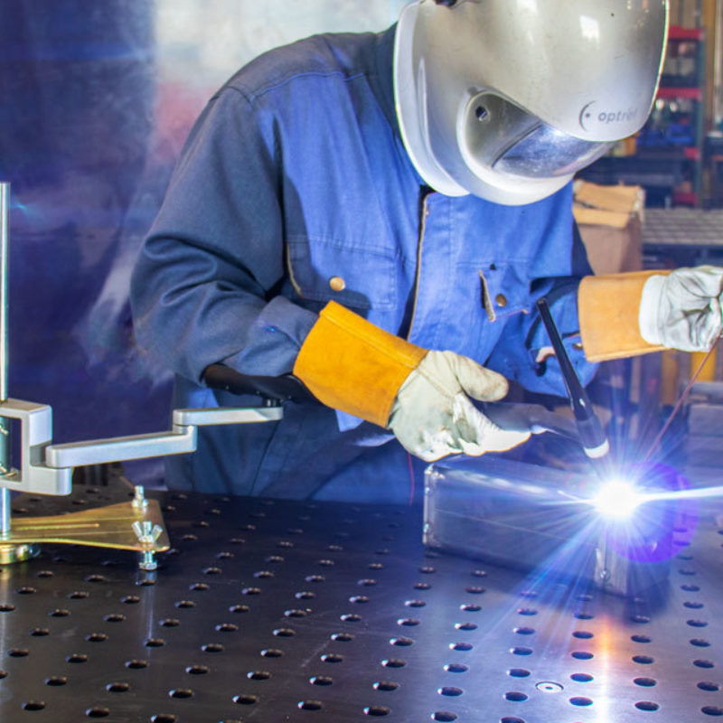 A welder using Strong Hand Adjustable Articulated Arm Rest Welding Support whilst welding