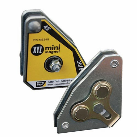 Two yellow and black Strong Hand magnets with metallic parts, designed for securing 2 or 3-axis work pieces in a welding setup.